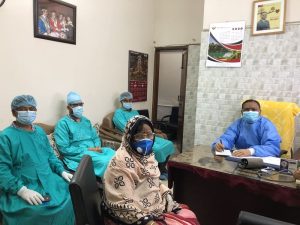 Professor AKM Manzurul Alam at his chamber with a patient and staff