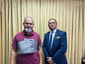 the cardiac surgeon taking a picture with his patient